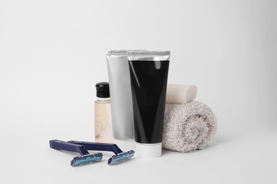 Different men's shaving accessories on light background