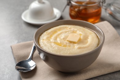 Photo of Delicious semolina pudding served on grey table