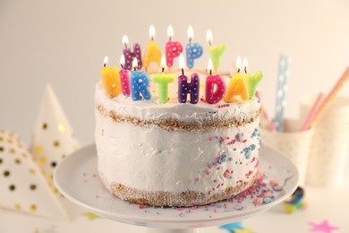 Tasty Birthday cake with burning candles on white table, closeup