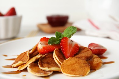 Cereal pancakes with strawberries on plate, closeup