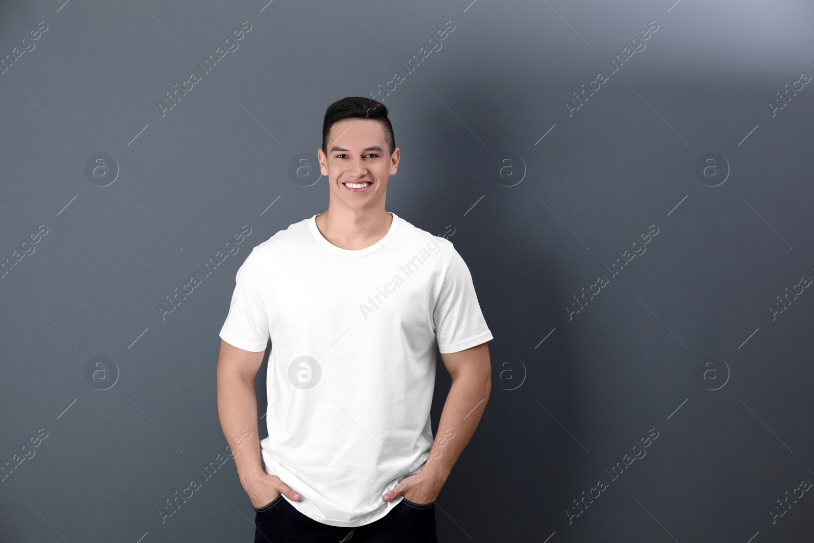 Photo of Young man in white t-shirt on color background. Mockup for design