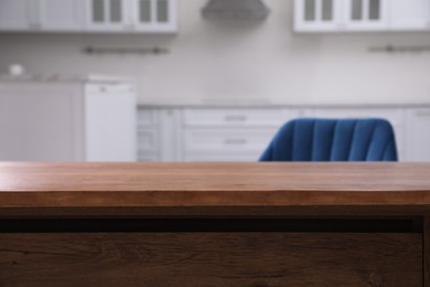 Photo of Wooden table and armchair indoors, closeup. Modern furniture