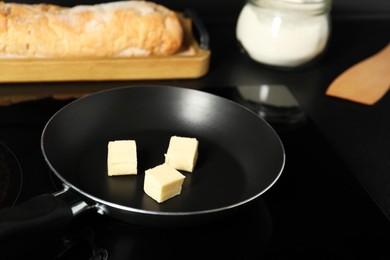 Photo of Melting butter in frying pan on cooktop