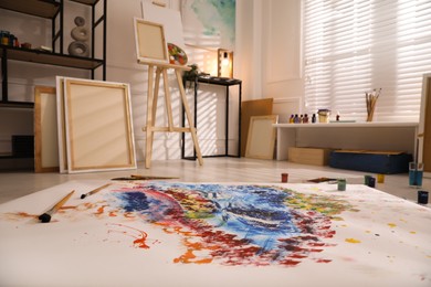 Wooden easel and abstract picture in art studio
