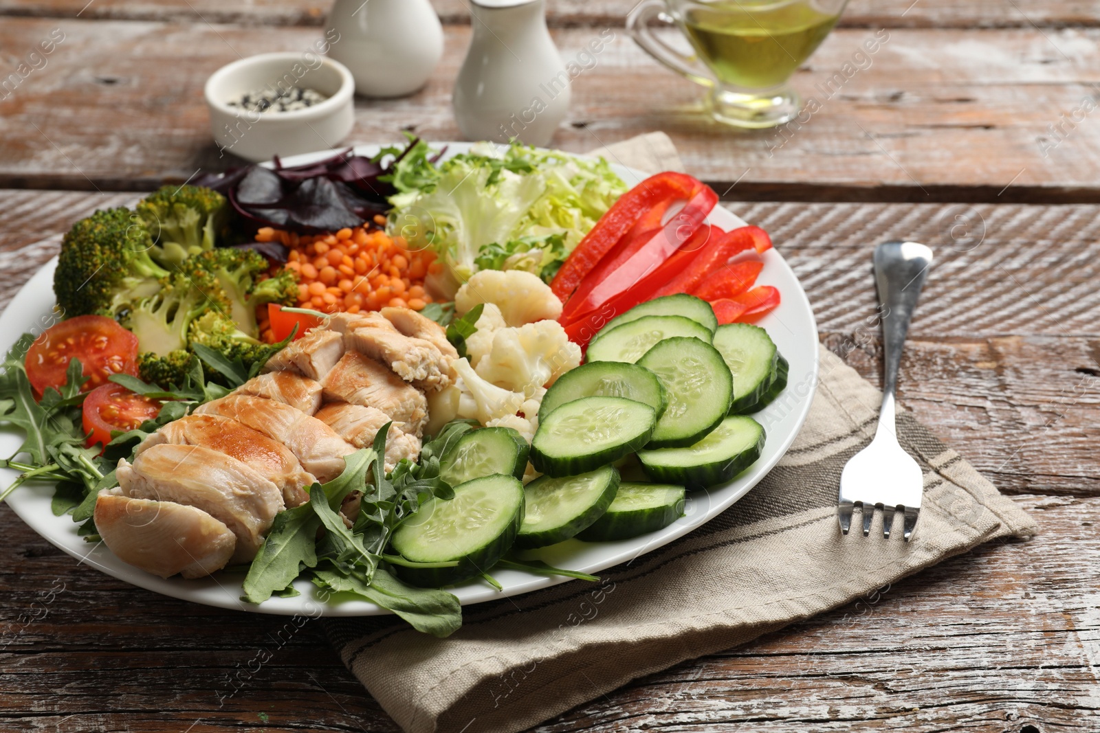 Photo of Balanced diet and healthy foods. Plate with different delicious products on wooden table