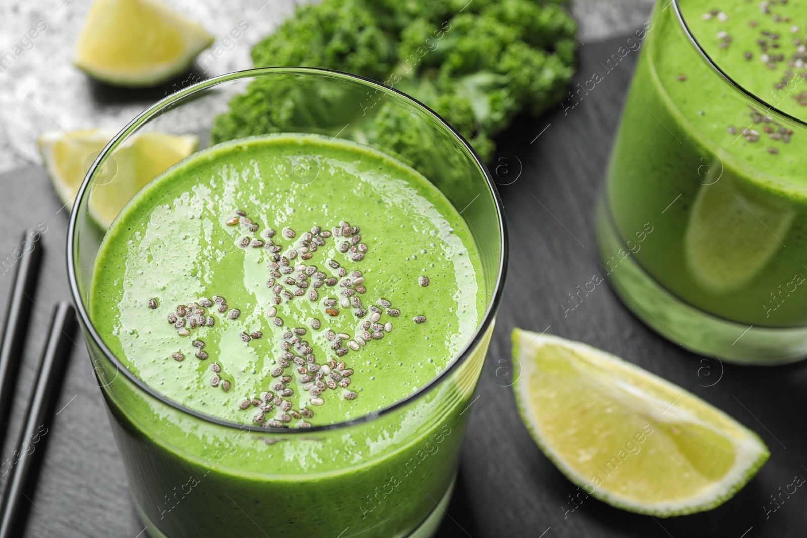 Photo of Tasty kale smoothie with chia seeds on table, closeup