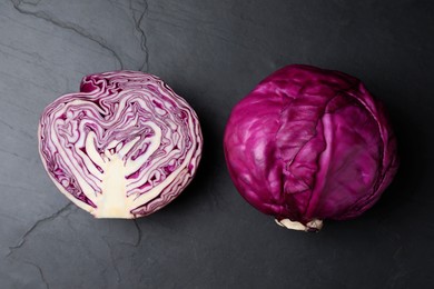 Photo of Tasty fresh red cabbages on black table, top view