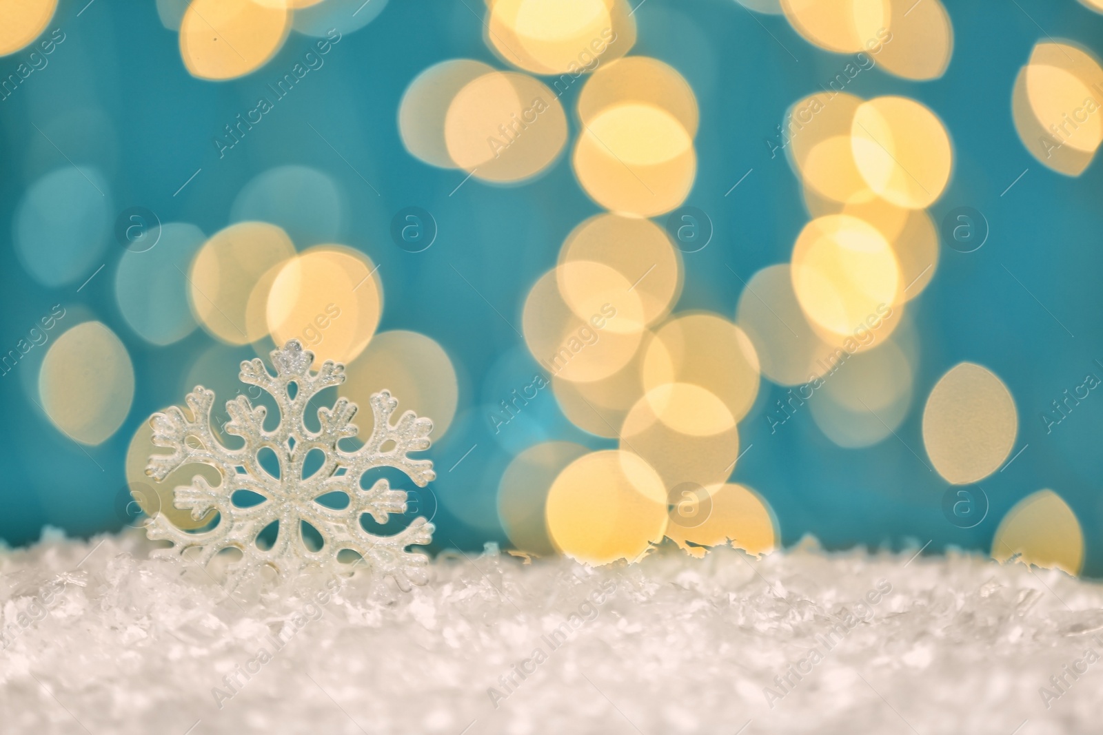 Photo of Beautiful decorative snowflake against blurred festive lights, space for text