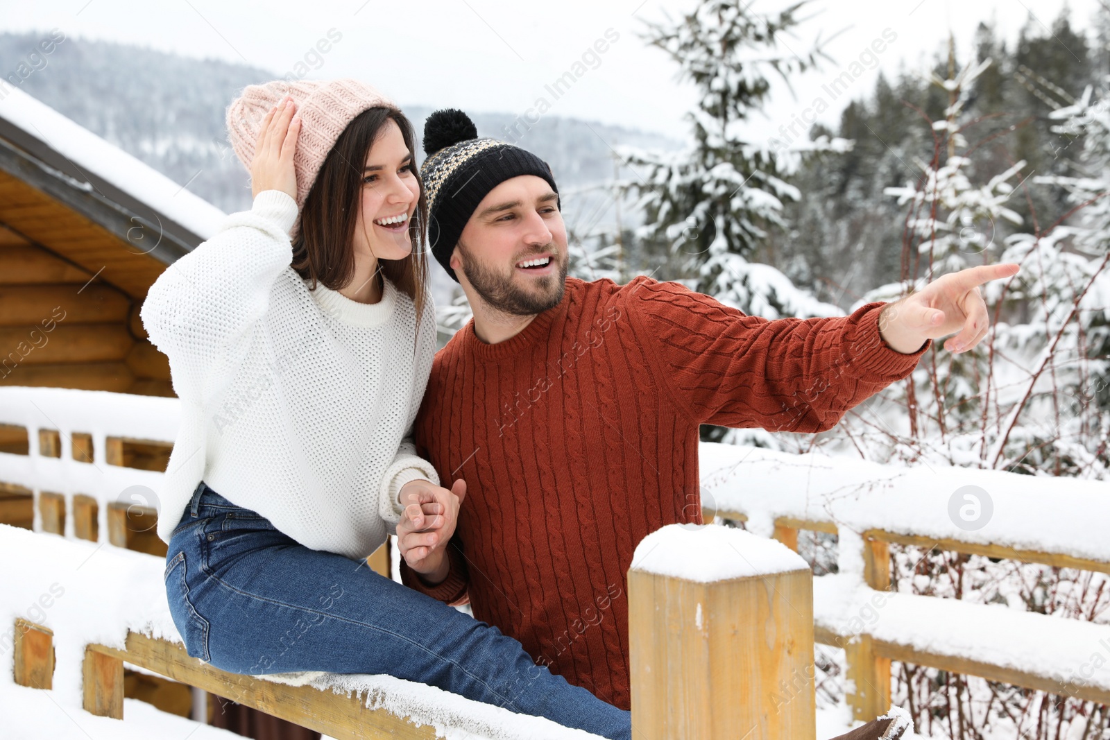 Photo of Happy couple in warm sweaters outdoors on winter day