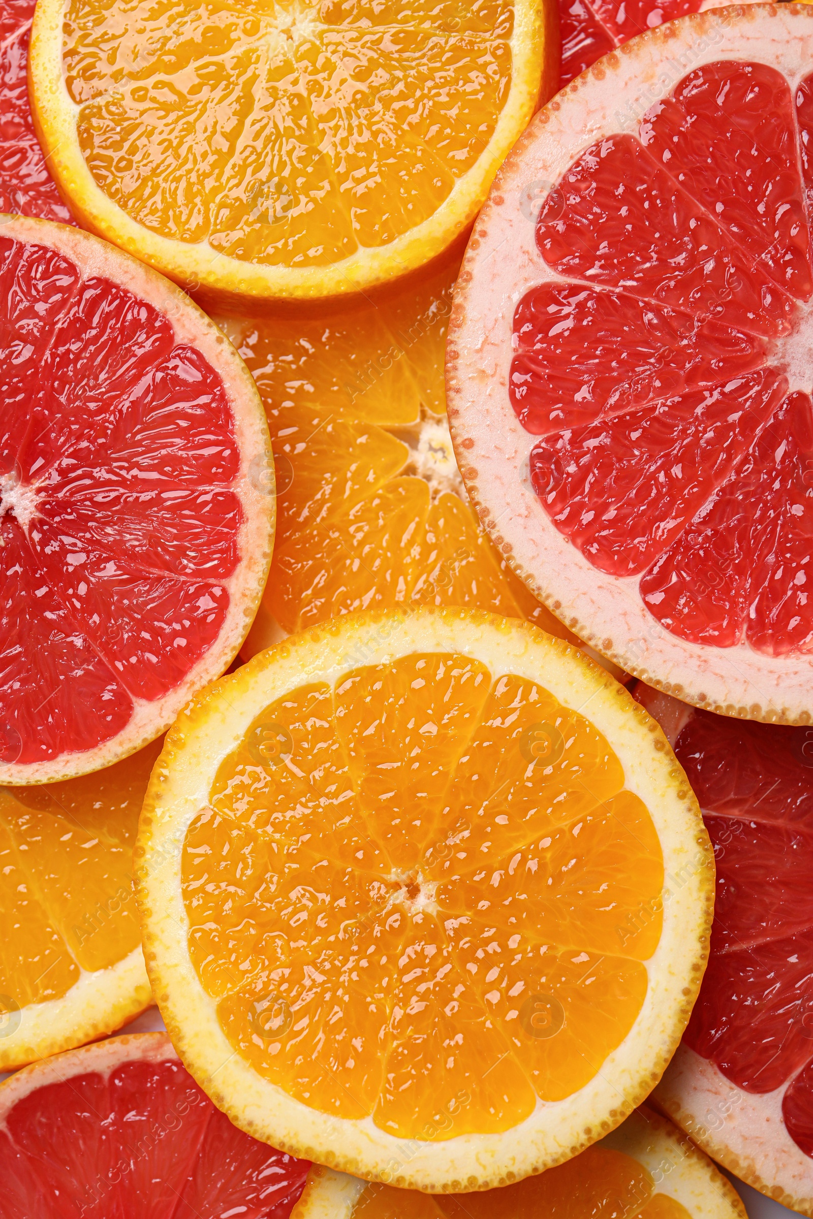 Photo of Slices of grapefruit and orange as background, top view