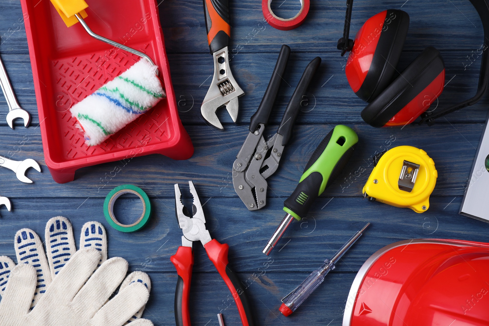 Photo of Flat lay composition with different construction tools on blue wooden background