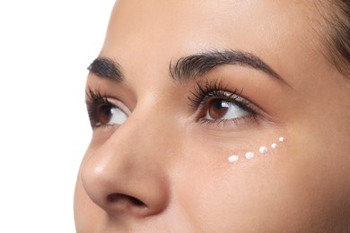 Woman with eye cream on white background, closeup. Skin care