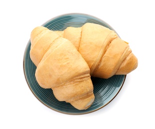 Tasty croissants on plate against white background, top view