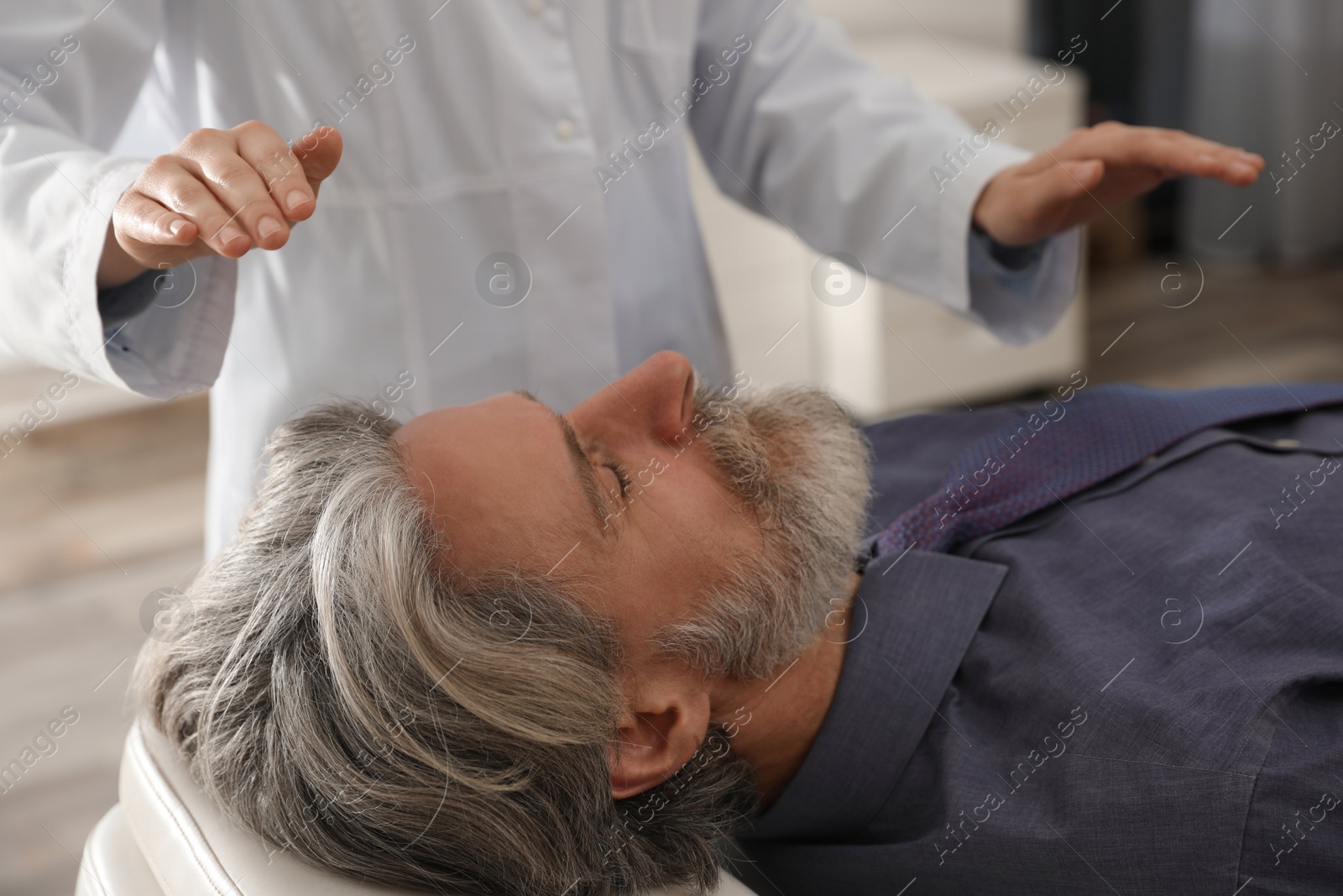 Photo of Psychotherapist and patient in office. Hypnotherapy session