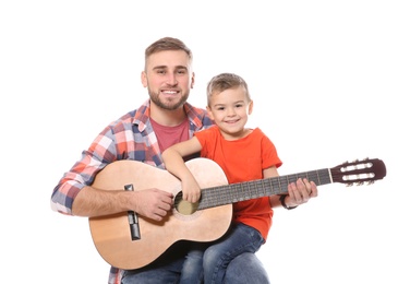 Photo of Father teaching his little son to play guitar on white background