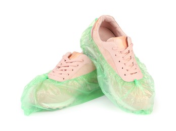 Sneakers in green shoe covers isolated on white