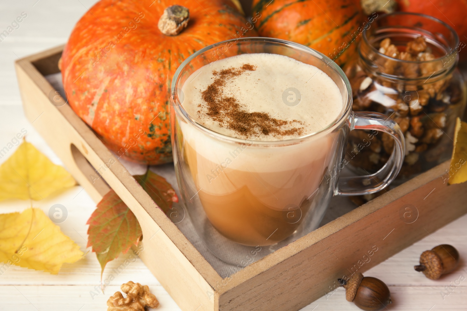 Photo of Composition with cup of tasty pumpkin spice latte on table