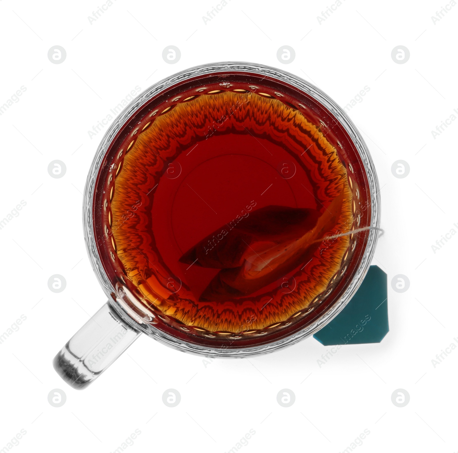 Photo of Tea bag in glass cup of hot water isolated on white, top view