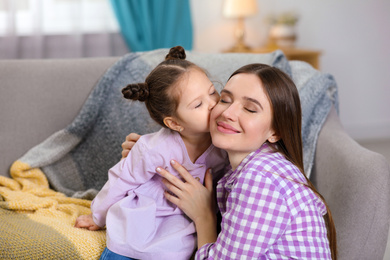 Young mother with little daughter at home