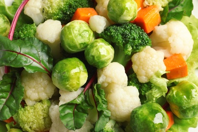 Salad with Brussels sprouts and broccoli as background, top view