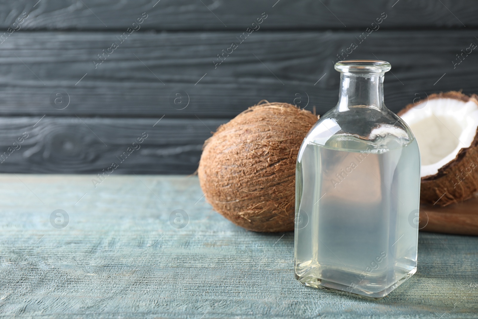 Photo of Coconut oil on light blue wooden table, space for text