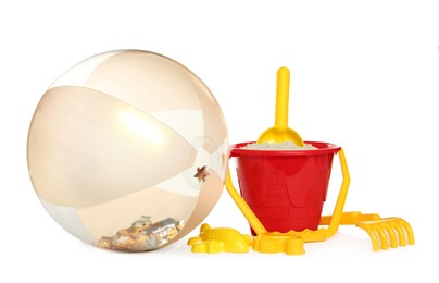 Inflatable beach ball and child plastic toys on white background