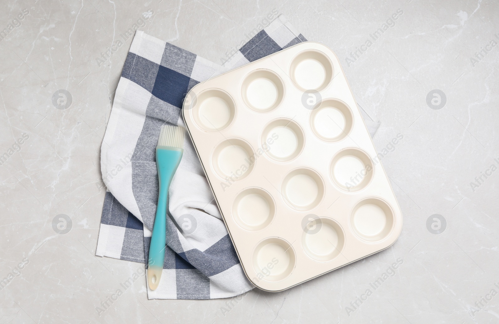 Photo of Baking dish and brush on grey table, flat lay. Cooking utensils