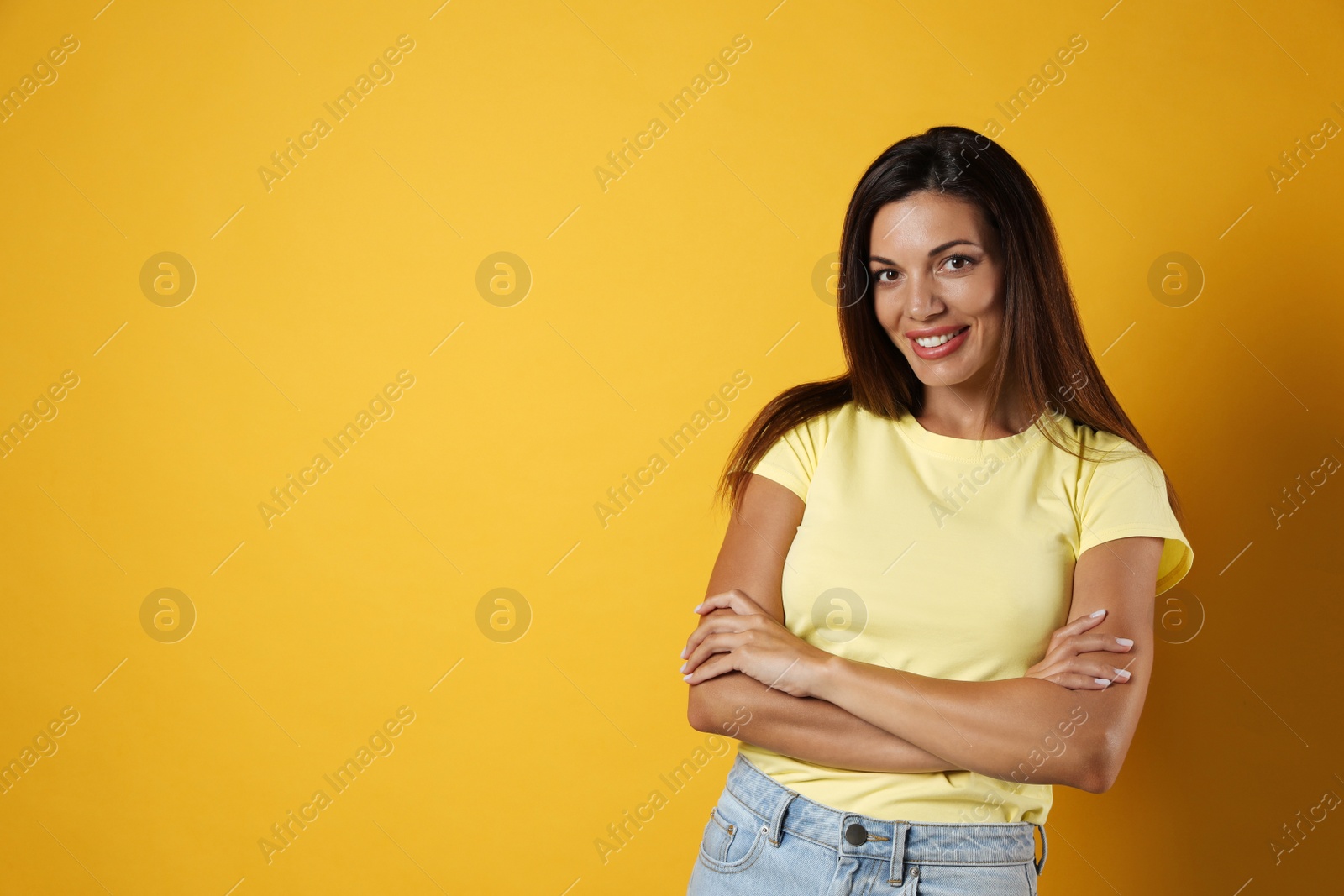 Photo of Portrait of beautiful woman on yellow background, space for text