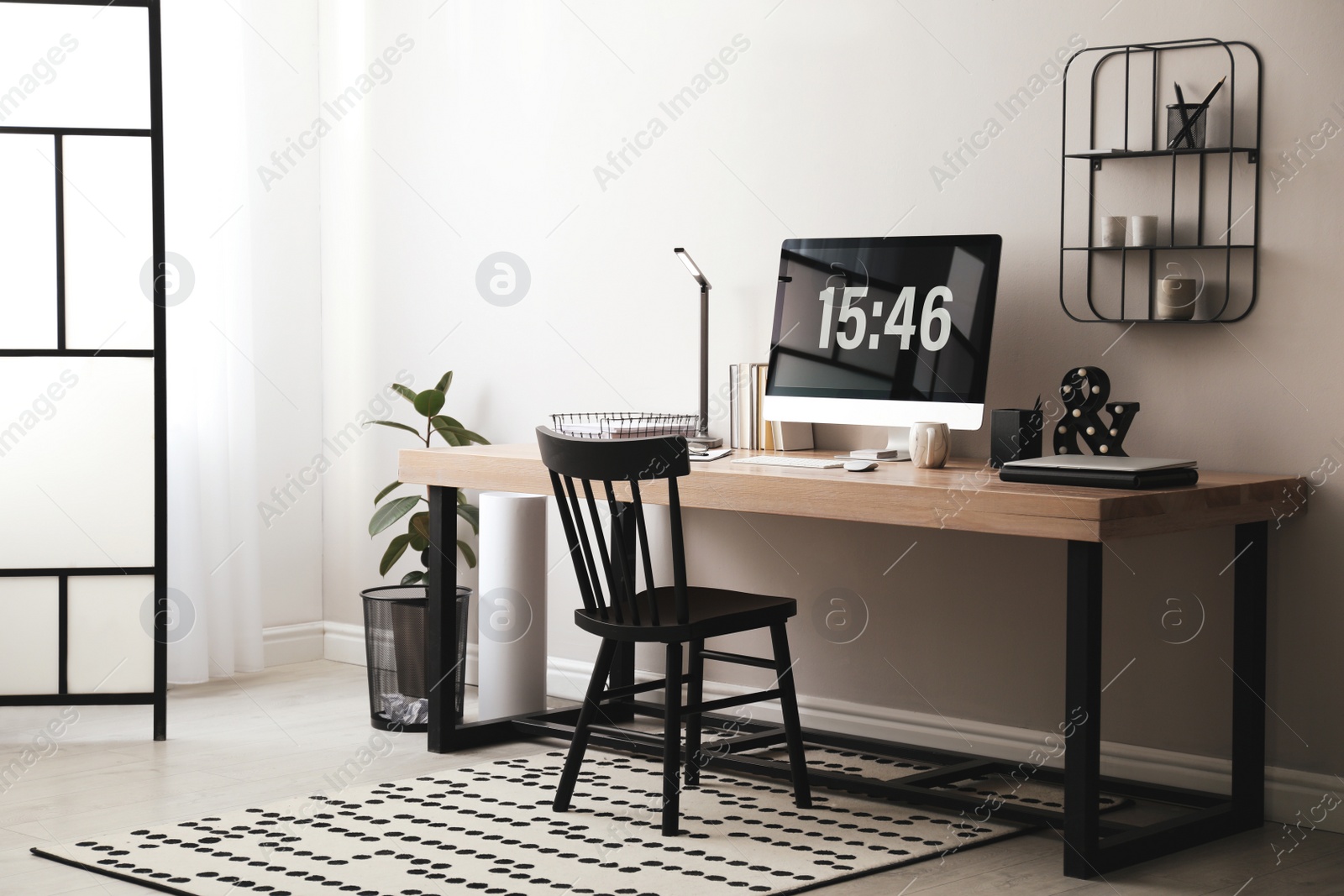 Photo of Modern workplace with computer in room. Interior design