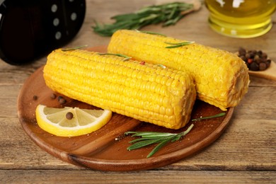 Photo of Delicious boiled corn served on wooden table. Sous vide cooking
