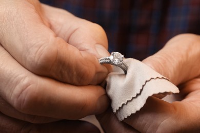 Professional jeweler working with ring, closeup view
