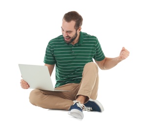 Photo of Emotional young man with laptop celebrating victory on white background