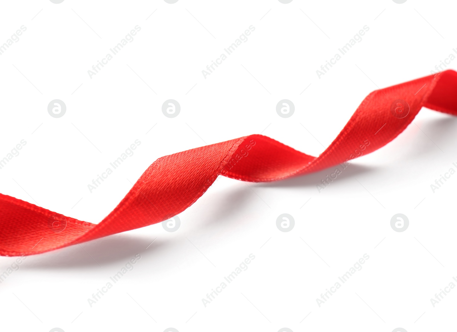 Photo of Simple red ribbon on white background. Festive decoration