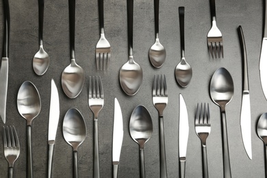 Photo of Forks, knives and spoons on table, top view