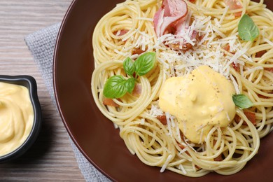 Photo of Delicious spaghetti with meat and cheese sauce on wooden table, flat lay