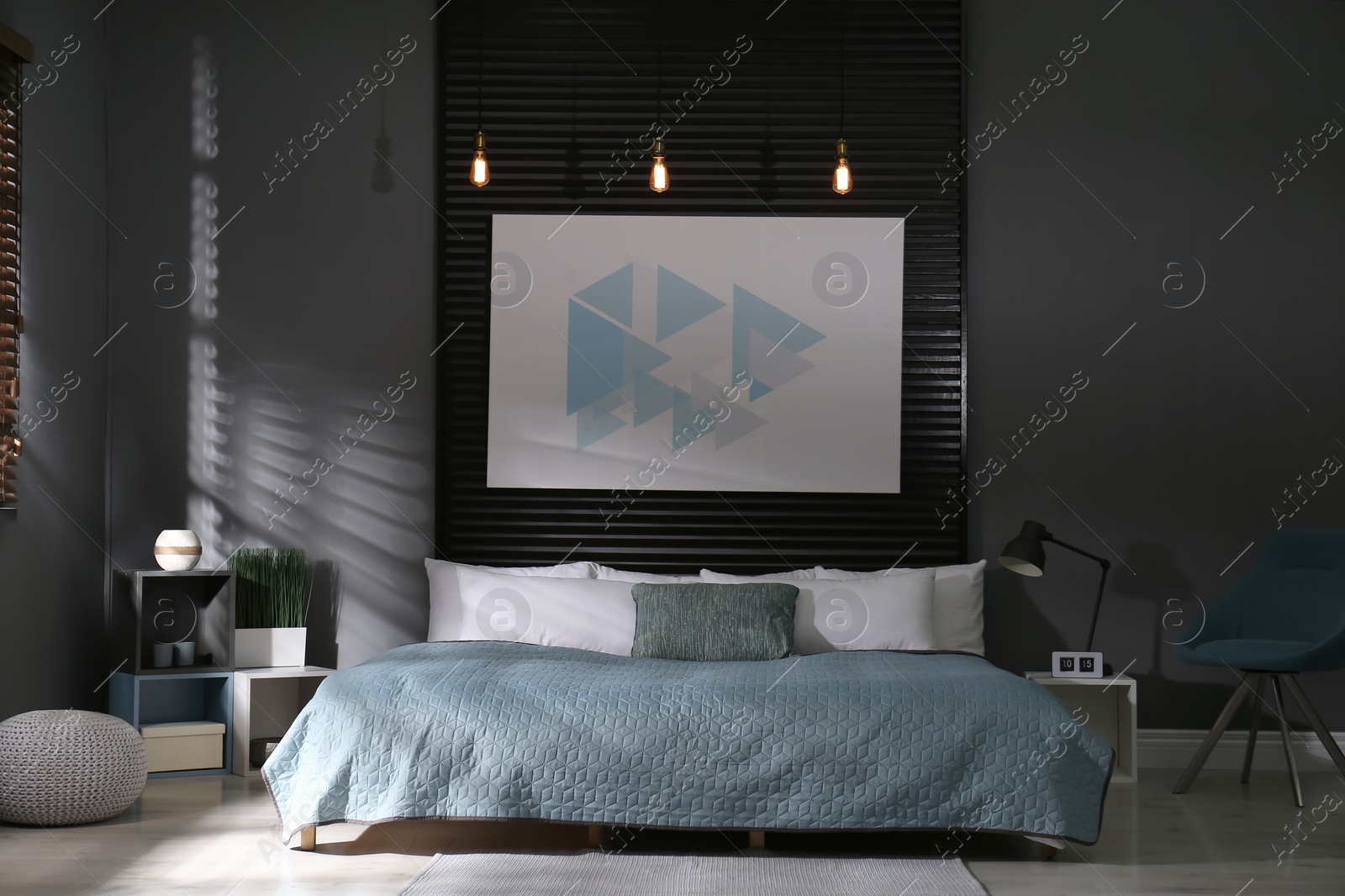 Photo of Comfortable bedroom with picture on decorative wall. Interior design