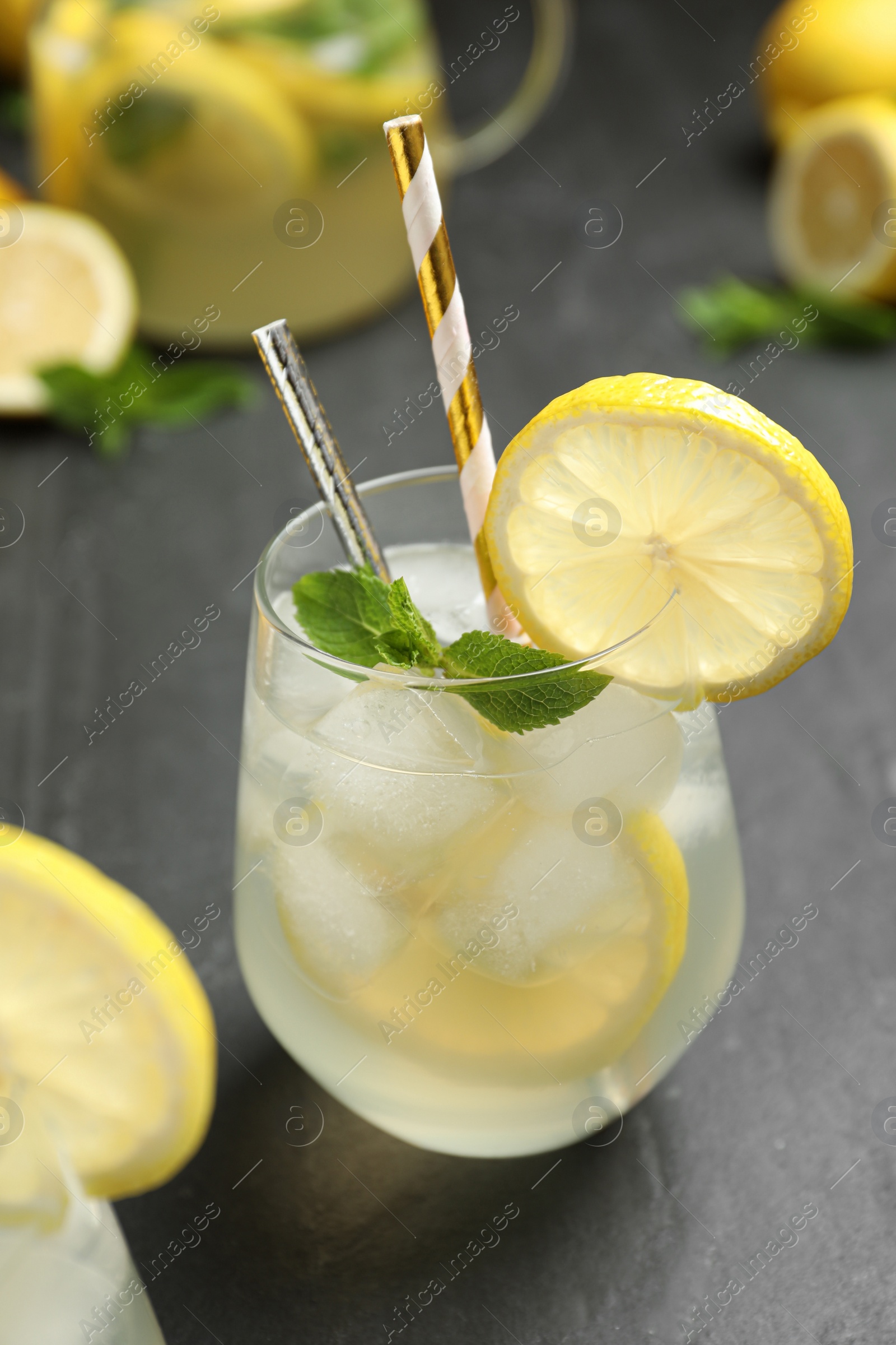 Photo of Natural lemonade  with mint on grey table, closeup. Summer refreshing drink