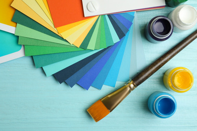 Photo of Flat lay composition with color palettes on light blue wooden background