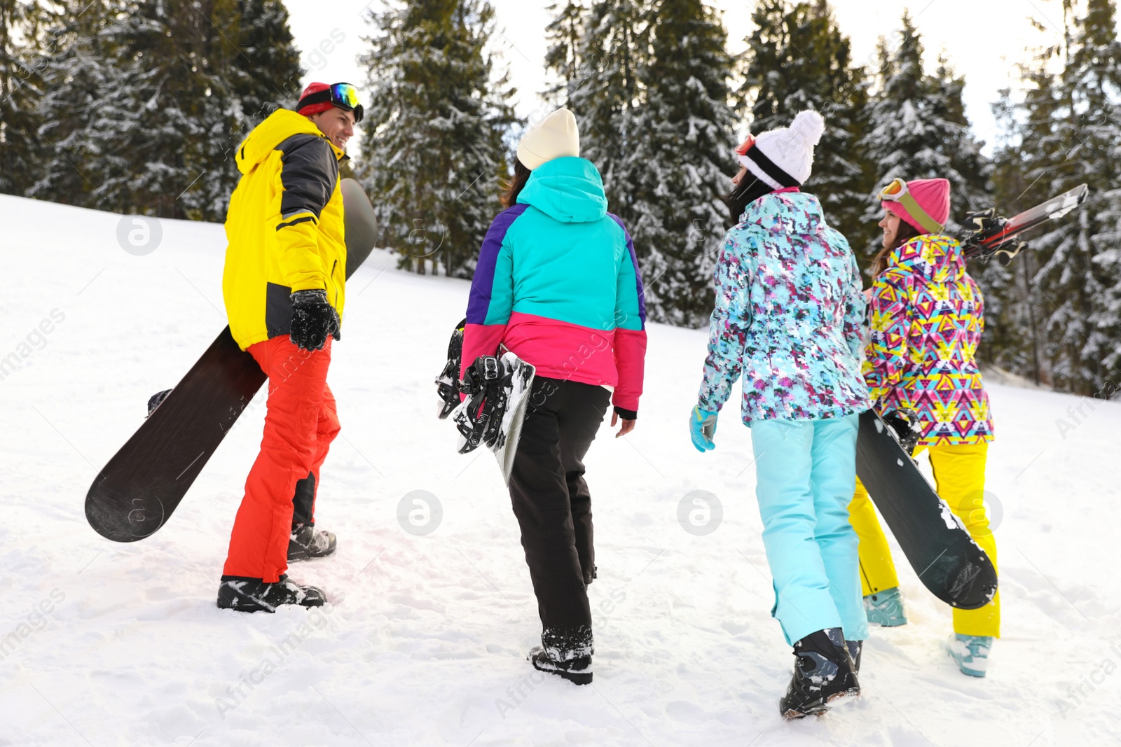 Photo of Group of friends with equipment in snowy mountains. Winter vacation