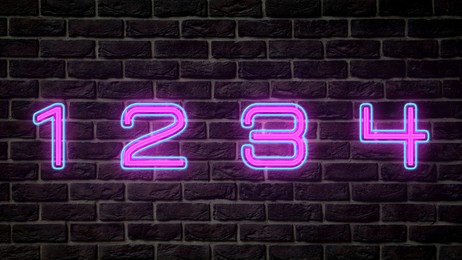 Image of Glowing neon number (1, 2, 3, 4) signs on brick wall