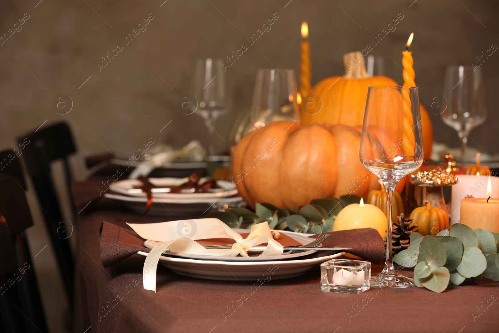 Photo of Beautiful autumn place setting and decor on table in room