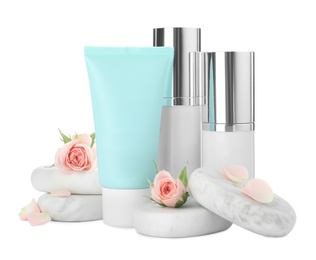 Photo of Cosmetic products, spa stones and flowers on white background