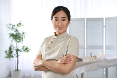 Photo of Portrait of young Asian masseuse in spa salon