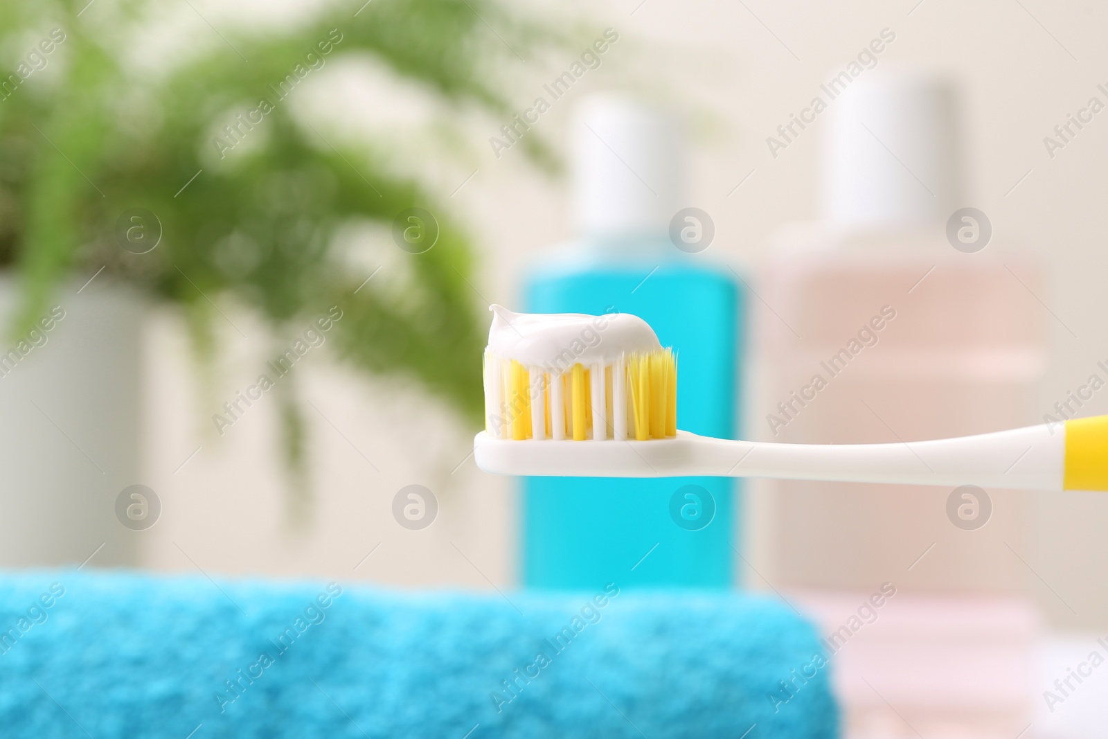 Photo of Brush with toothpaste on blurred background, closeup