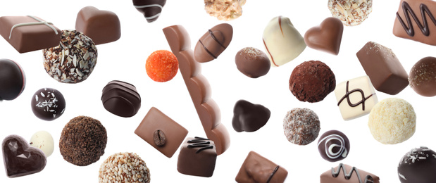 Image of Different chocolate candies falling on white background. Banner design