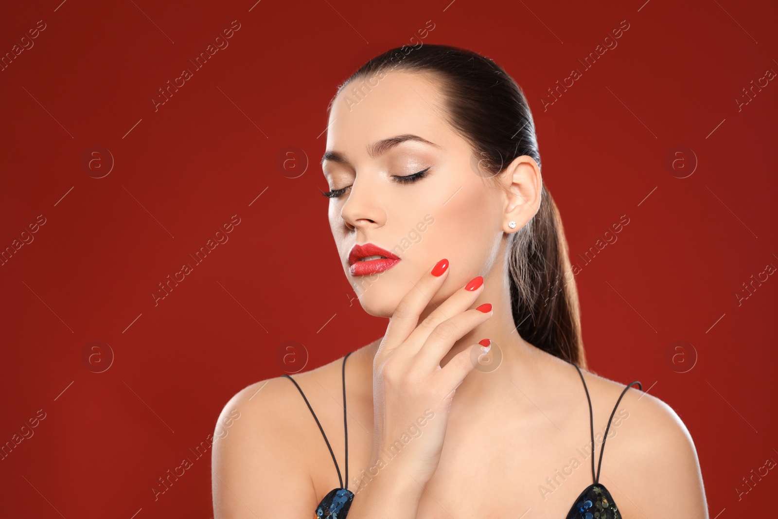 Photo of Portrait of beautiful young woman with bright manicure on color background. Nail polish trends