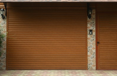 Building with brown roller shutter garage door