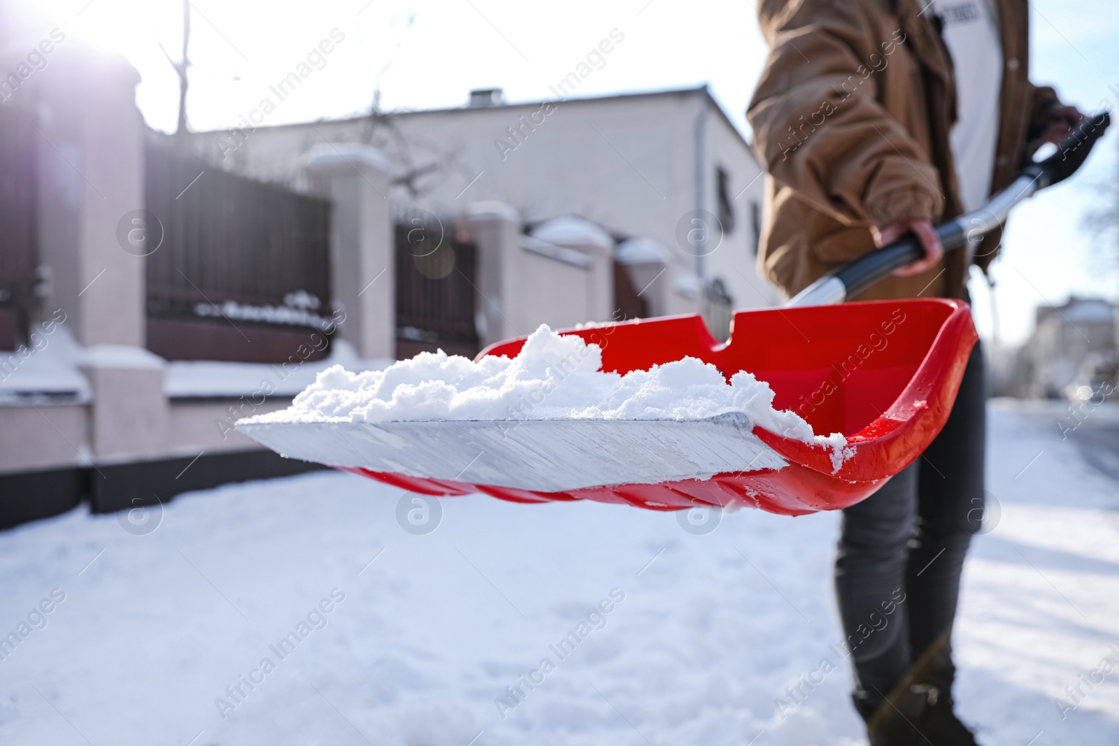 Photo of Person shoveling snow outdoors on winter day, closeup