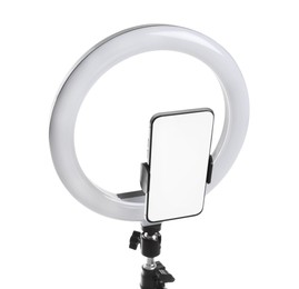 Photo of Modern tripod with ring light and smartphone isolated on white