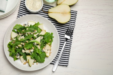 Photo of Tasty salad with pear slices served on white wooden table, flat lay. Space for text